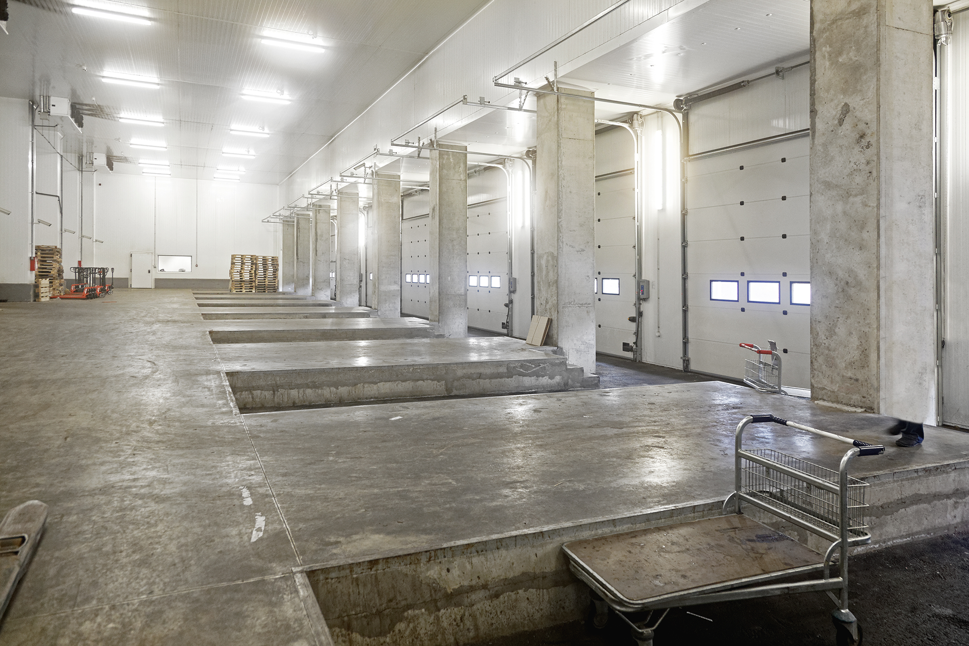 Inside look at industrial loading bay featuring overhead doors and concrete ramps in Boyle Heights, CA